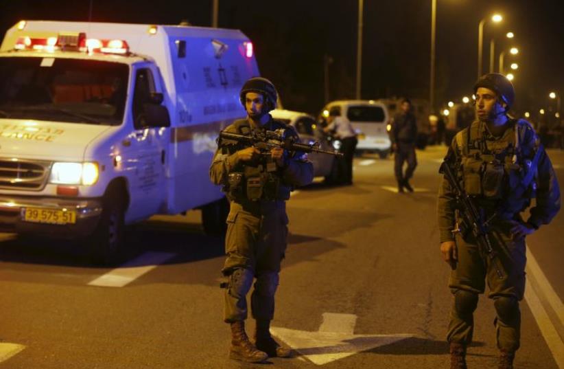 IDF soldiers near the scene of a Palestinian attack near the West Bank [File] (photo credit: REUTERS)