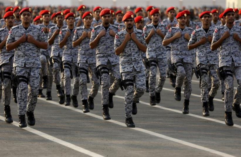 Members of Saudi security forces take part in a military parade (photo credit: REUTERS)