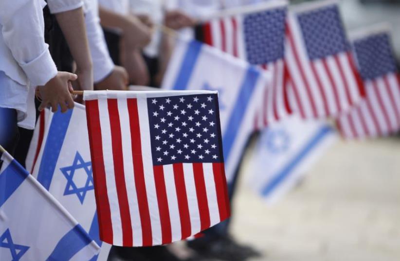Israeli schoolchildren hold the Israeli and American flags (photo credit: REUTERS)