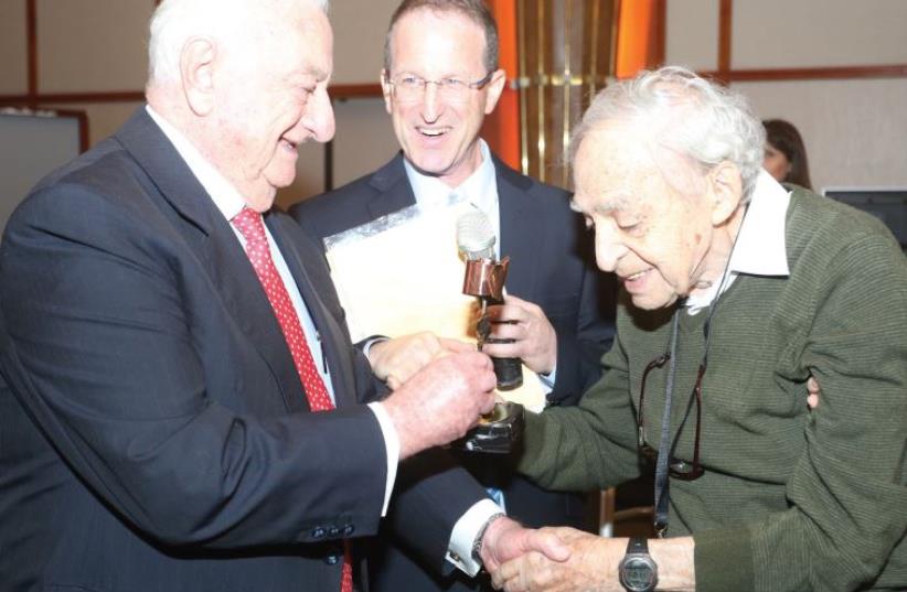 Dr. Zvi Harry Tabor (right), founding father of Israel’s solar energy industry shown receiving an Energy Man of the Year award last month. Handing Tabor the title is businessman Yeshayahu Landau (left), as EcoEnergy CEO Amit Mor looks on (photo credit: YAEL TZUR)