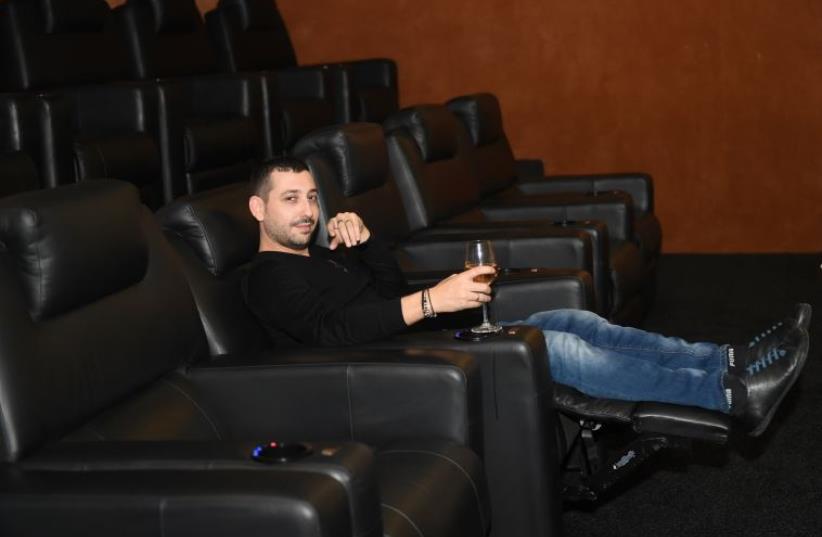 DJ and bar owner Mike Zof gets cozy with champagne at his personal screening of the Star Wars film in Petach Tikva, December 16, 2015. (photo credit: ADI VILDER)
