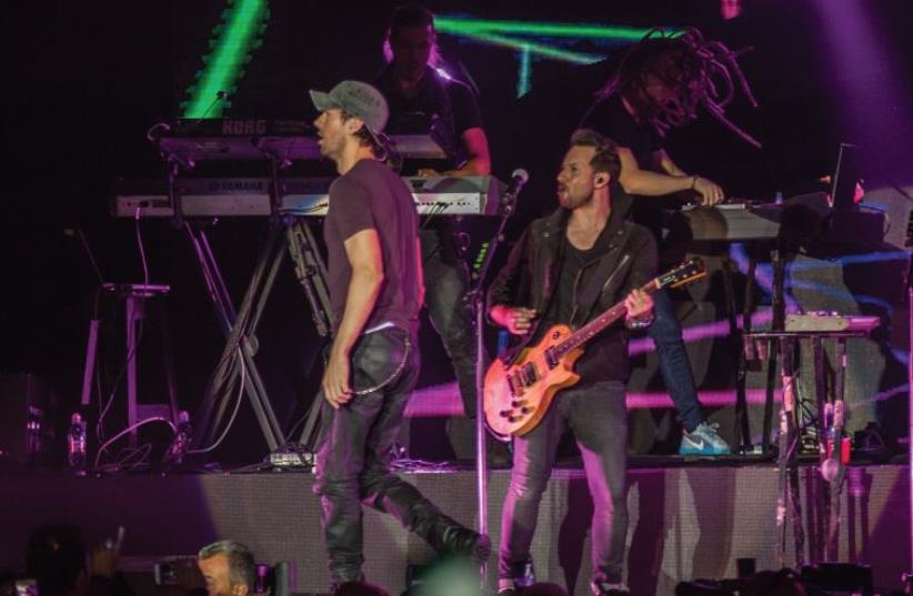 ISRAELI GUITARIST Sean Hurwitz (center, right) performing onstage with Latin heartthrob Enrique Iglesias at the Menora Mivtachim Arena in Tel Aviv. ( (photo credit: LIOR KETER)