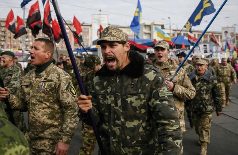 MEMBERS OF the Svoboda right-wing party take part in a Day of Defender march in Kiev in October, along with other radical groups (photo credit: REUTERS)