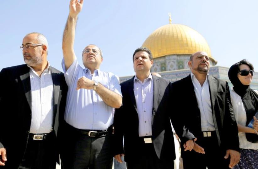 Lawmakers from the Joint Arab List stand in front of the Dome of the Rock during a visit to the compound in Jerusalem's Old City, July 28 (photo credit: REUTERS)