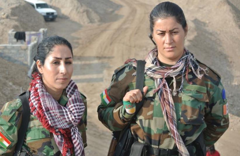 Two Kurdish Peshmerga pose for a photo at the frontline northwest of Mosul. Women fighters make up one-third of the Kurdistan Freedom Party’s forces (photo credit: SETH J. FRANTZMAN)