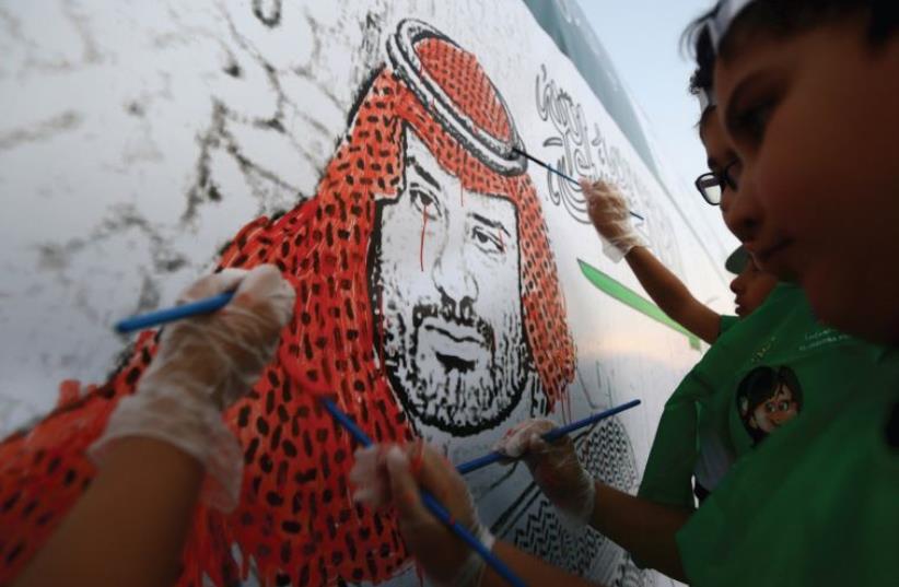 Saudi boys paint a mural depicting Saudi Arabia’s Deputy Crown Prince and Defense Minister Mohammed bin Salman in Jeddah on October 29 (photo credit: REUTERS)
