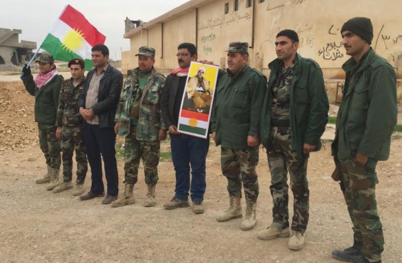 KURDISH SUPPORTERS of the PDK party from Rojava in Syria serving in a peshmerga unit in The Kurdistan Regional Government of Iraq. The YPG in Syria doesn’t allow PDK units to operate there, one of many examples of how divided politics exists in the shadow of support for independence (photo credit: SETH J. FRANTZMAN)