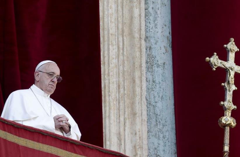Pope Francis delivers a "Urbi et Orbi" message from the balcony overlooking St. Peter's Square at the Vatican December 25, 2015 (photo credit: REUTERS)