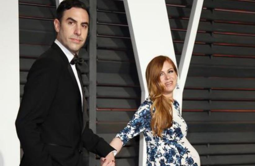 Actors Sasha Baron Cohen and Isla Fisher arrive at the 2015 Vanity Fair Oscar Party in Beverly Hills, California February 22, 2015.  (photo credit: REUTERS)