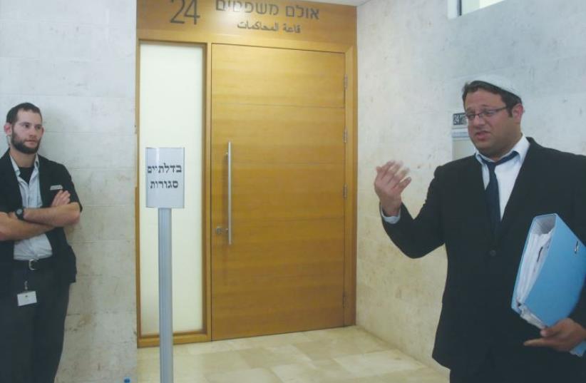 ATTORNEY ITAMAR BEN-GVIR, who is representing one of the suspects in the Duma terrorist attack, waits outside the Petah Tikva Magistrate’s Court (photo credit: MARC ISRAEL SELLEM)