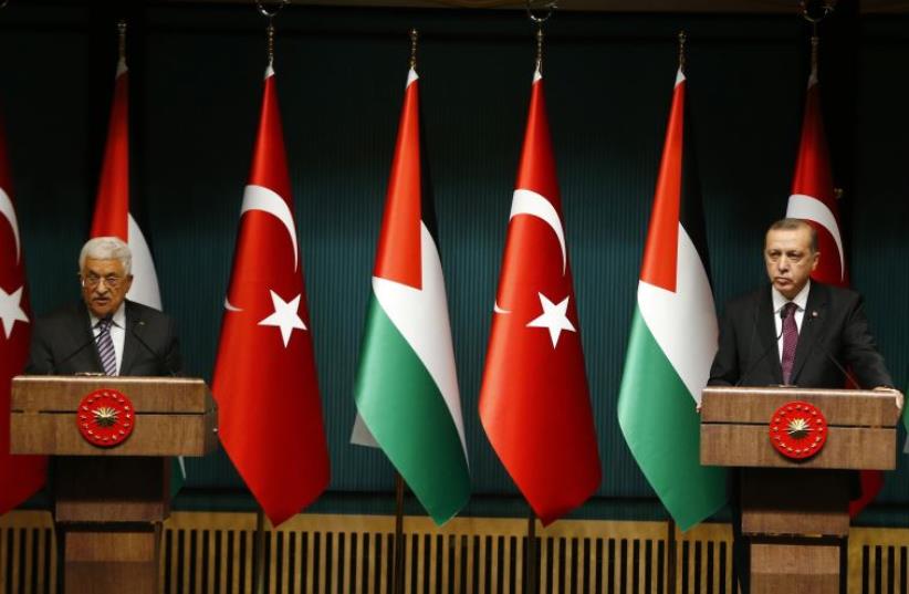 Turkey's President Tayyip Erdogan and Palestinian President Mahmoud Abbas (L) address the media at the Presidential Palace in Ankara January 12, 2015 (photo credit: REUTERS)