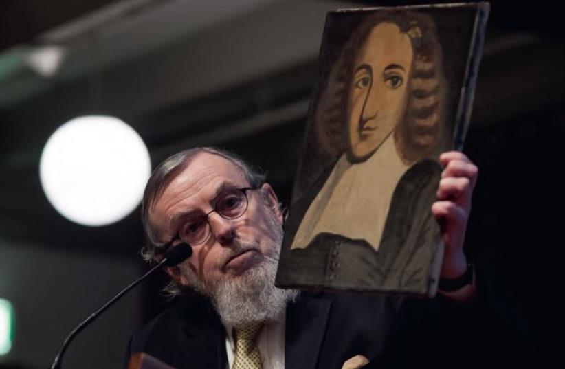 NATHAN LOPES CARDOZO holding a portrait of Spinoza that his father had painted in the time of the Holocaust (photo credit: CLAUDIA KAMERGORODSKI)