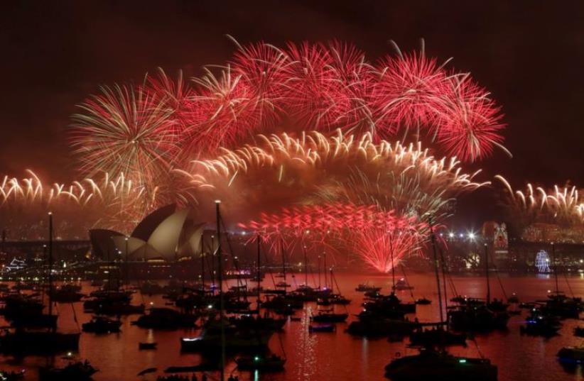 Fireworks explode over the Sydney Opera House and Harbour Bridge as Australia's largest city ushers in the New Year (photo credit: REUTERS)