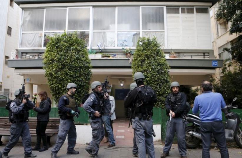 Israeli policemen search for suspects near the scene of a shooting incident in Tel Aviv (photo credit: REUTERS)