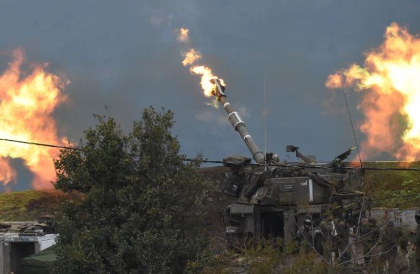 An IDF artillery gun fires a shell into Lebanon, after a roadside bomb exploded next to an IDF military border patrol near the Sheba Farms area near Kiryat Shmona, Israel, January 4, 2016. (photo credit: REUTERS)