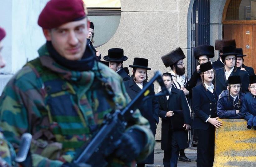 BELGIAN PARATROOPERS stand watch outside a Jewish school in Antwerp on January 17, 2015, following a police raid on an Islamist terrorist group in the nearby city of Verviers (photo credit: REUTERS)
