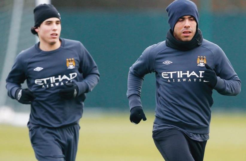 Gai Assulin (left) has trained with some of the world’s best players – including Carlos Tevez (right) (photo credit: REUTERS)