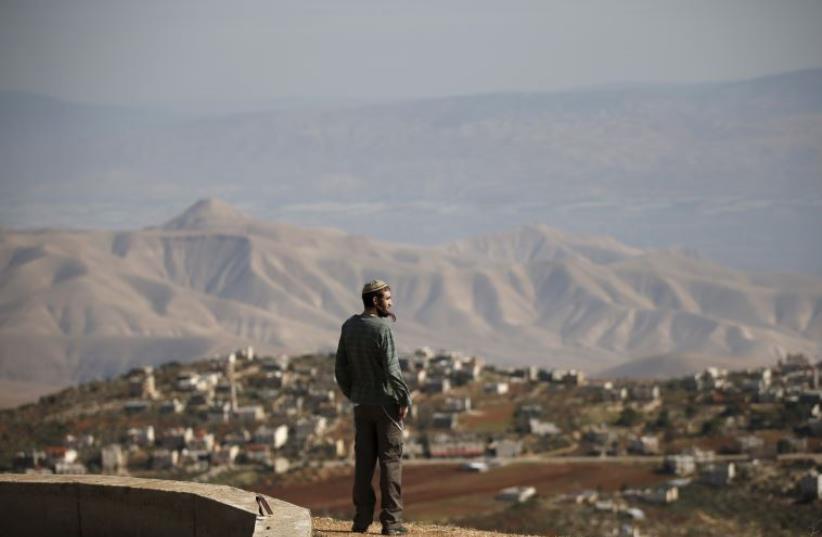 Jewish settler Refael Morris stands at an observation point overlooking the West Bank village of Duma, near Yishuv Hadaat, an unauthorized Jewish settler outpost (photo credit: REUTERS)