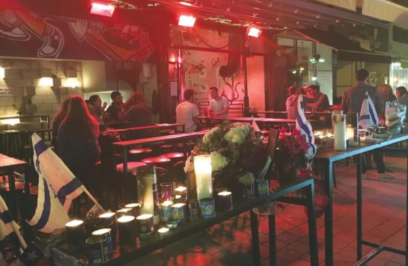Mourning candles light the entrance to Tel Aviv’s Hasimta Bar on Friday, as it reopened following the previous week’s terrorist attack (photo credit: NIV ELIS)