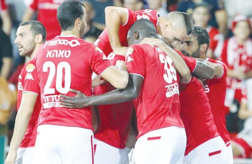 Hapoel Beersheba players had good reason to celebrate last night after beating Maccabi Petah Tikva 1-0 on the road to extend their lead at the top of the Premier League standings. (photo credit: DANNY MARON)