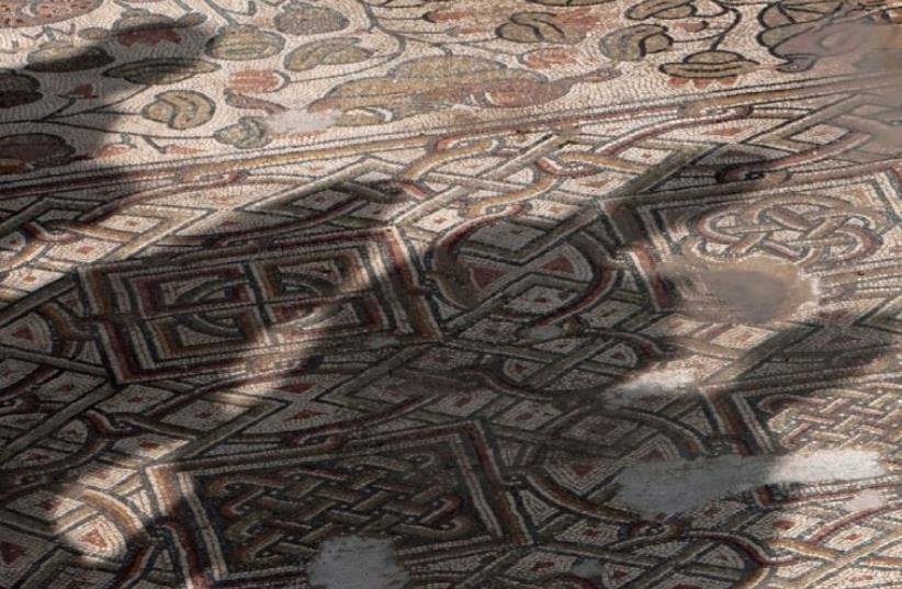 THE SHADOW of members of the media is cast on a mosaic floor of an ancient church found near Jerusalem in 2011. In the 19th century, Crusader mosaic floors were uncovered in the Dome of the Rock. (photo credit: REUTERS)