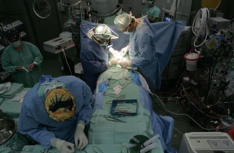 Israeli doctors perform heart surgery on a baby from Gaza, at Wolfson Hospital near Tel Aviv  (photo credit: REUTERS)