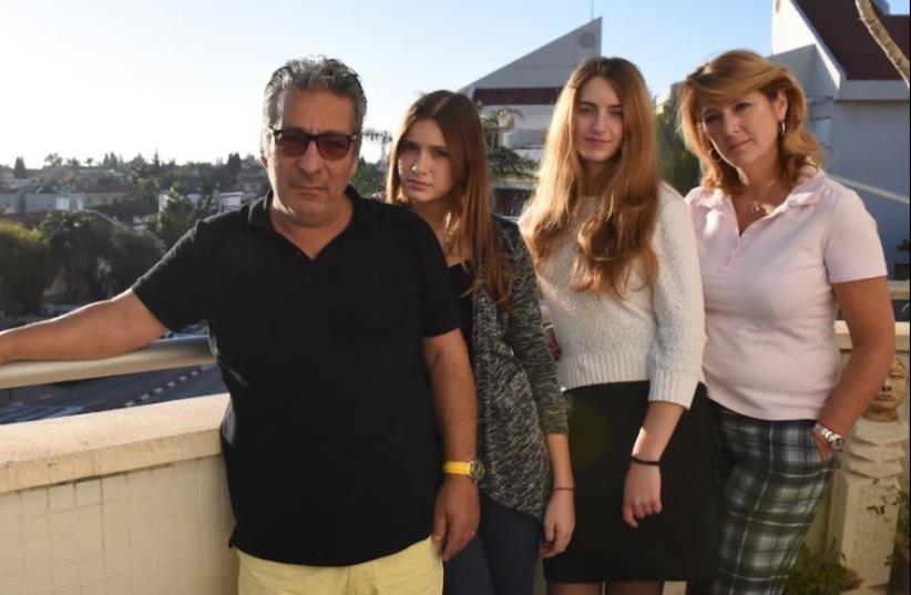 Catherine Berdah, right, with her husband and daughters in their apartment in Raanana, Israel. (photo credit: JTA)