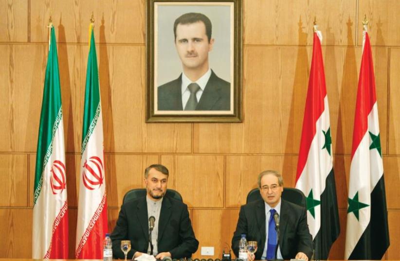 Iran's Deputy Foreign Minister Hossein Amir- Abdollahian (left) sits next to Syria’s Deputy Foreign Minister Faisal Mekdad during a joint press conference in Damascus on September 3, 2015 (photo credit: REUTERS)