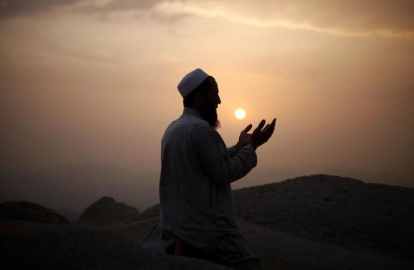 A Muslim pilgrim prays atop Mount Thor in the holy city of Mecca ahead of the annual haj pilgrimage (photo credit: REUTERS)