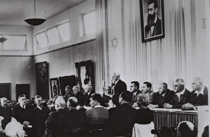 David Ben-Gurion, flanked by the members of his provisional government, reads the Declaration of Independence in the Tel Aviv Museum Hall (photo credit: GPO)