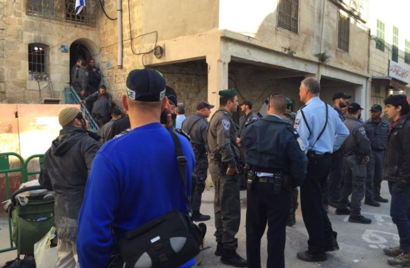 Security forces evacuate Jewish families from a building in Hebron, January 22, 2016 (photo credit: RACHEL BEN ARI)