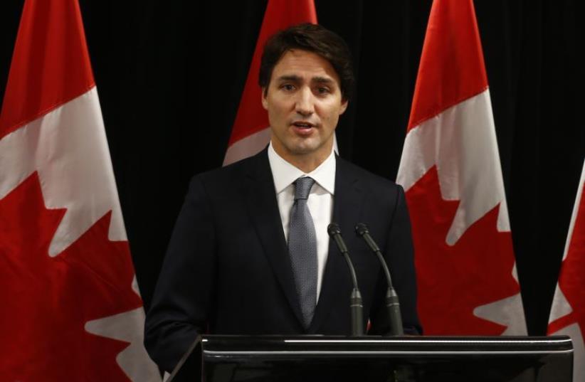 Canadian Prime Minister Justin Trudeau speaks about a Saskatchewan school shooting during a news conference in Davos, January 22, 2016.  (photo credit: REUTERS)