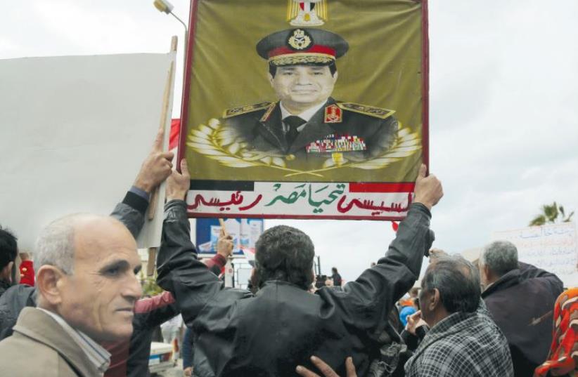 Pro-government protester chants slogans while holding a poster of Egyptian President Abdel Fattah al-Sisi as people gather in Alexandria, on the fifth anniversary of the uprising that ended the 30-year reign of Hosni Mubarak, on Monday (photo credit: REUTERS)