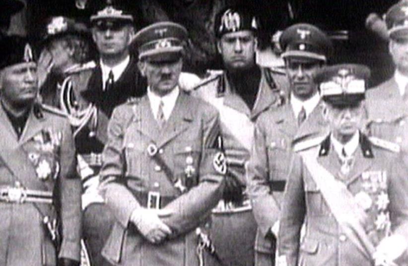 King Victor Emanuel III, (R) Adolf Hitler (C) and Benito Mussolini (L) watch fascist troops march past from a balcony in central Rome in this 1941 television file footage (photo credit: REUTERS)