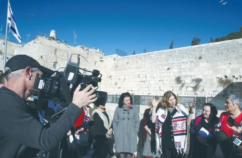 ANAT HOFFMAN (center), director of Women of the Wall, speaks to reporters at the Kotel yesterday. (photo credit: MARC ISRAEL SELLEM)
