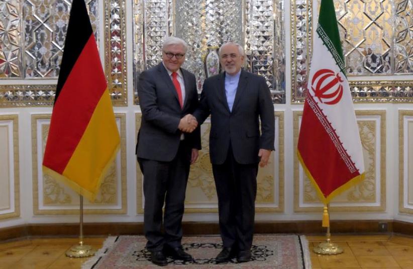 Iranian Foreign Minister Mohammad Javad Zarif (R) shakes hands with his German counterpart Frank-Walter Steinmeier in Tehran February 2, 2016 (photo credit: REUTERS)