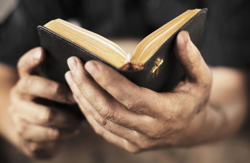 Man holding a bible (photo credit: INGIMAGE)