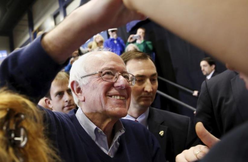Democratic US presidential candidate Bernie Sanders shakes hands with supporters during a rally in New Hampshire (photo credit: REUTERS)