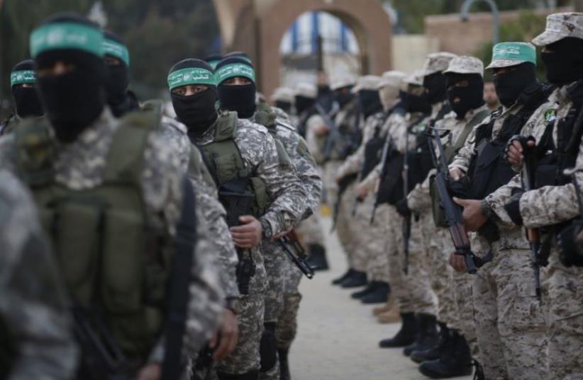 Palestinian Hamas militants take part in a rally in memory of their seven comrades, who were killed when a tunnel collapsed close to the Gaza Strip's eastern border with Israel (photo credit: REUTERS)