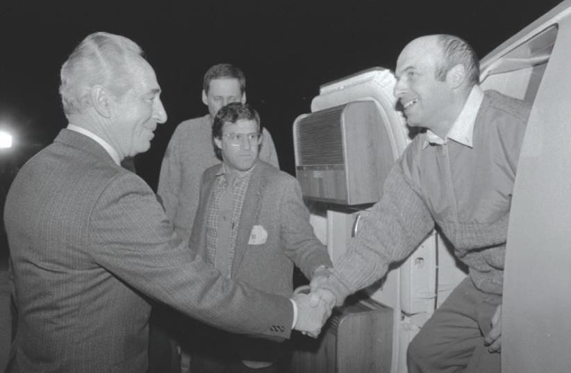 THEN PRIME MINISTER Shimon Peres greets newly released Prisoner of Zion Natan Sharansky at Ben-Gurion Airport where he was flown from Germany after being freed from a Soviet prison, exactly 30 years ago on Thursday or February 11, 1986. (photo credit: GPO)