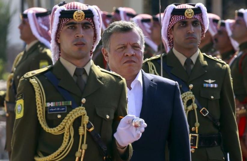 Jordan's King Abdullah II (2nd L) reviews an honor guard in Jordan's Red Sea port of Aqaba (photo credit: REUTERS)