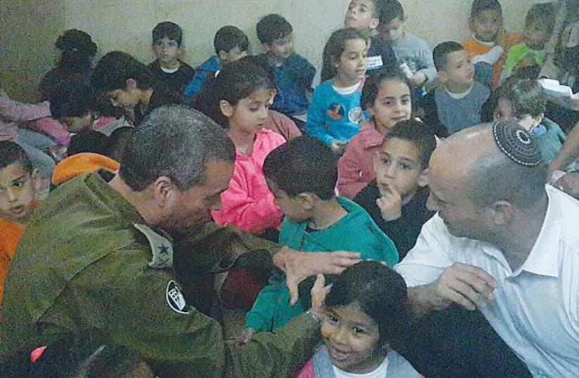 MAJ. GEN. YOEL STRICK, the head of Homefront Command, oversees a missile attack readiness drill with schoolchildren yesterday accompanied by Education Minister Naftali Bennett. (photo credit: Courtesy)