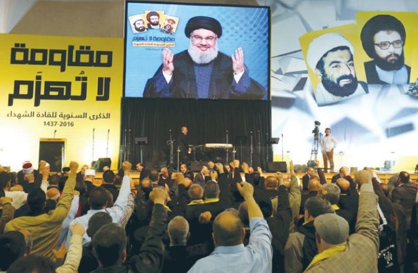 HEZBOLLAH LEADER Hassan Nasrallah addresses his supporters via a video link in Beirut, February 16, 2015 (photo credit: REUTERS)