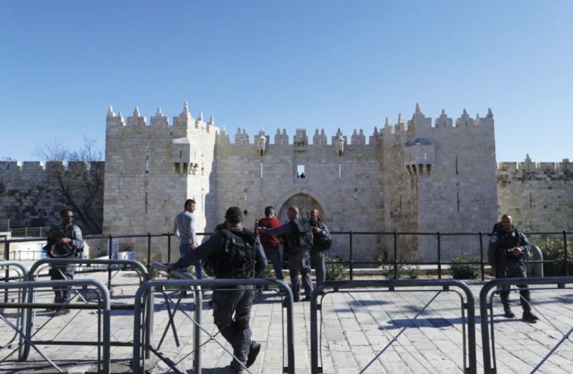BORDER POLICE frisk a Arab man in front of Jerusalem’s Damascus Gate, the scene of much recent violence. (photo credit: REUTERS)