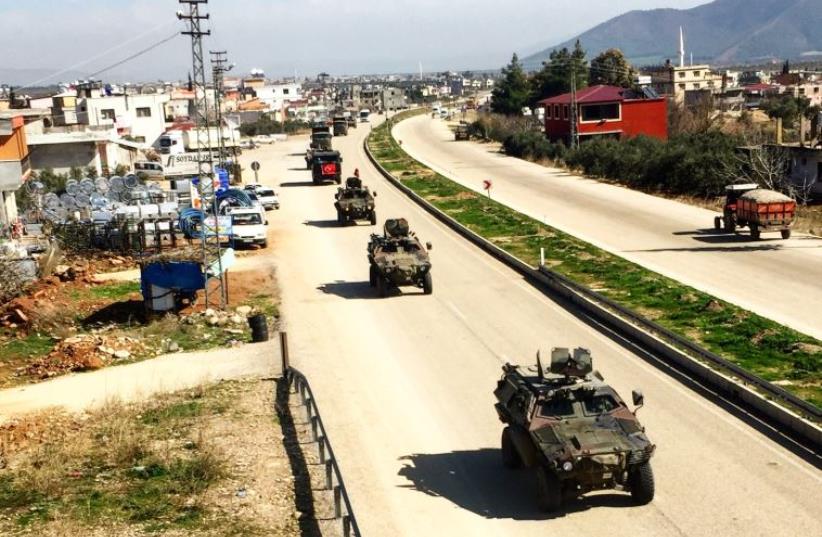 Turkish military vehicles drives through a town near the Syrian border (photo credit: SETH J. FRANTZMAN)