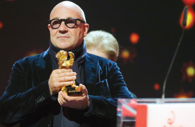 DIRECTOR GIANFRANCO ROSI receives the Golden Bear – Best Film award for the movie ‘Fire at Sea’ at the 66th Berlinale International Film Festival. (photo credit: REUTERS/FABRIZIO BENSCH)