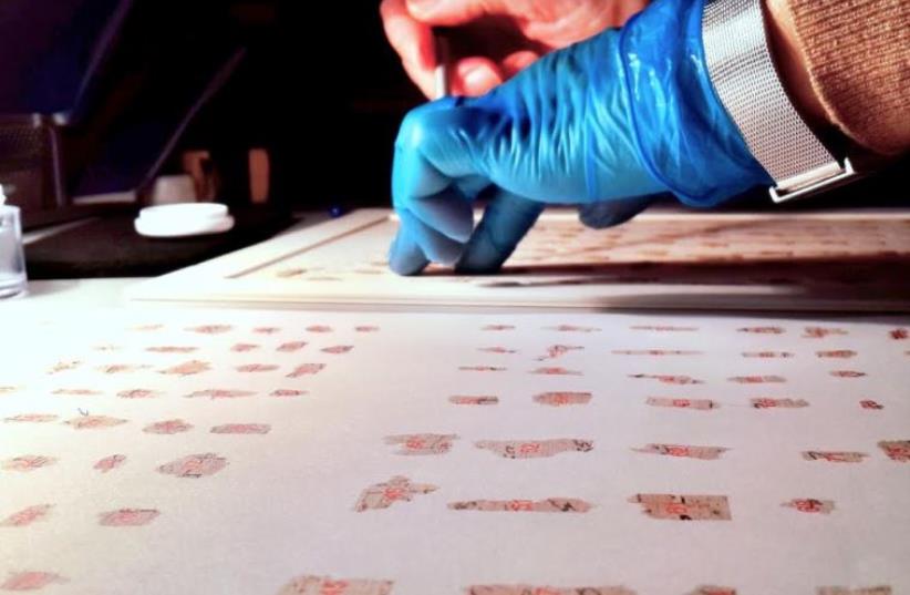 ANTIQUITIES AUTHORITY researchers utilize advanced technology to piece together thousands of fragments from the Dead Sea Scrolls.  (photo credit: IAA)