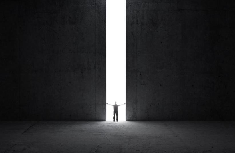 Man stands in the light  (photo credit: INGIMAGE)