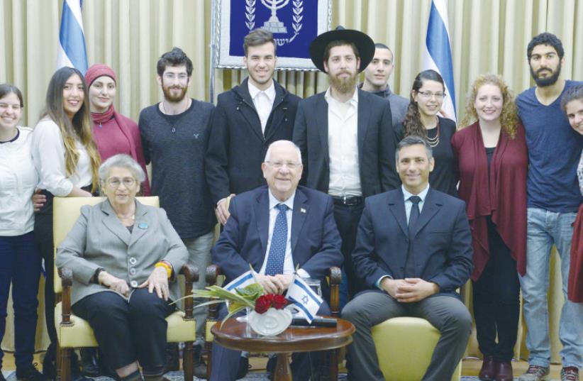 PRESIDENT REUVEN RIVLIN and his wife, Nechama, pose for a photo with participants of the ‘My Israeli Brother’ program at the President’s Residence yesterday (photo credit: Mark Neiman/GPO)