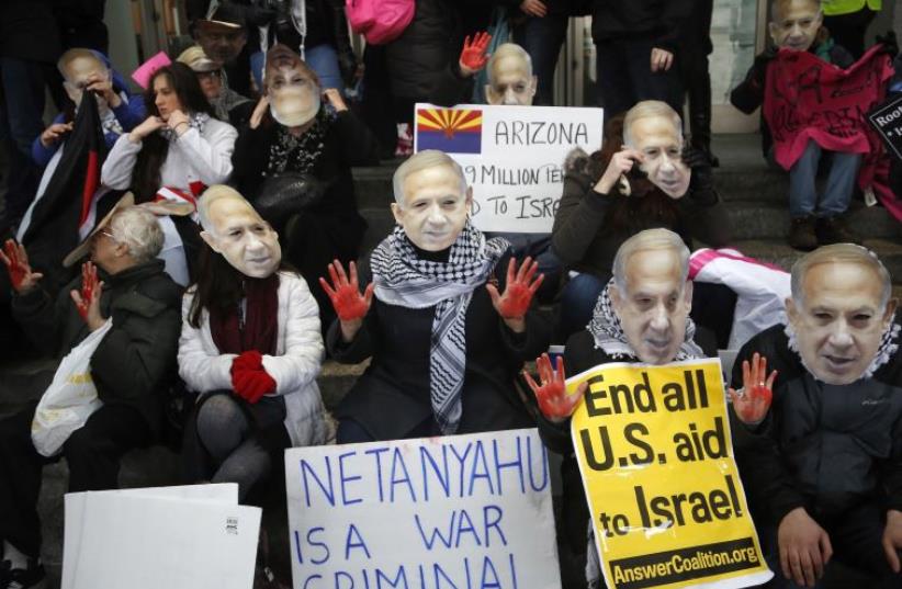  Anti-Israel demonstrators led by the protest group Code Pink wear masks of Prime Benjamin Netanyahu in Washington, March 1, 2015  (photo credit: REUTERS)